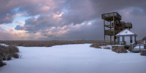 Sunset over a snow covered winter landscape in the floodplains of the river IJssel in The Netherlands.
