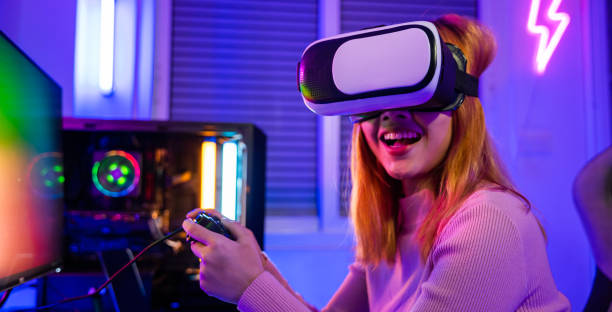 istock Gamer in VR headset glasses exploring metaverse play video game online with joystick 2200309364