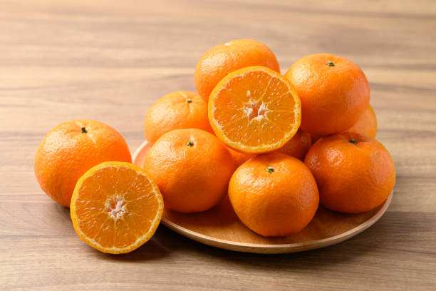 istock Mandarin tangerine orange fruit on wooden background 2200312713