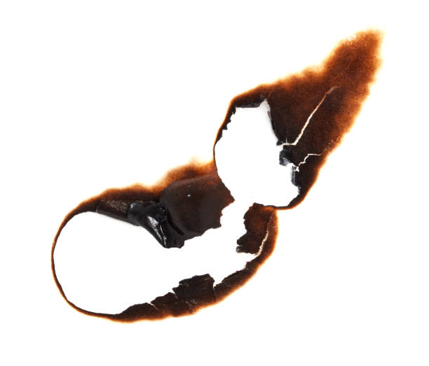 istock A burnt piece of paper with a hole in it 2200314420