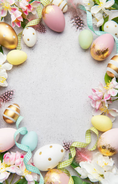 istock Easter eggs frame forming a circle on a gray background with flowers and feathers 2200314783