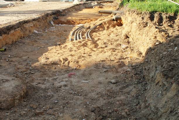 istock Trench excavation with exposed pipes or cables at a construction site. Earthwork, infrastructure, and urban development concept 2200315736