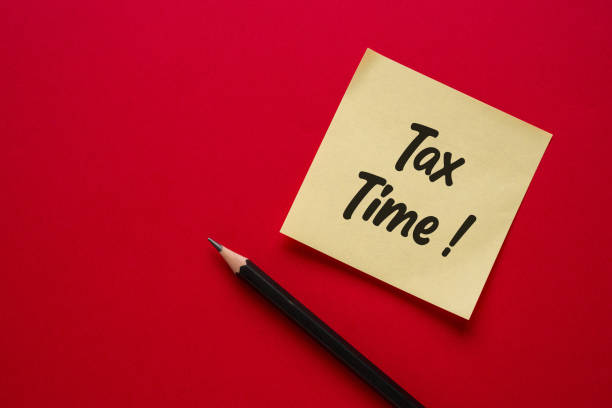 istock Top view of yellow sticky note with Tax Time written on it 2200317005