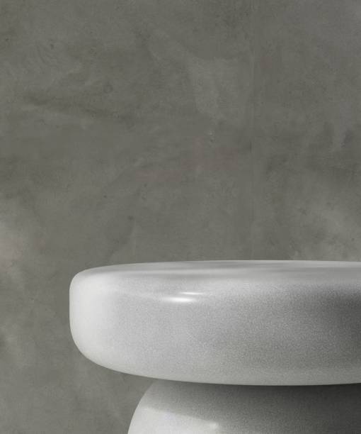 istock Glossy smooth round gray stone podium table in dappled sunlight on polished cement concrete wall for cosmetic, skincare, body care product podium background 3D 2200319318