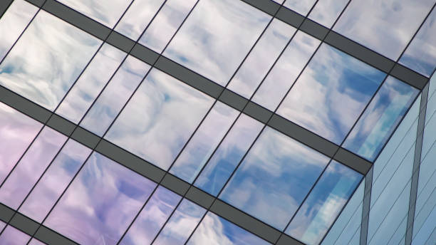 istock Sky Reflections on Glass. A dynamic view of clouds mirrored on a contemporary building. 2200319334