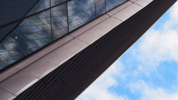 istock a sleek architectural angle where glass and metal textures meet, reflecting the sky in a modern, geometric composition. 2200319661