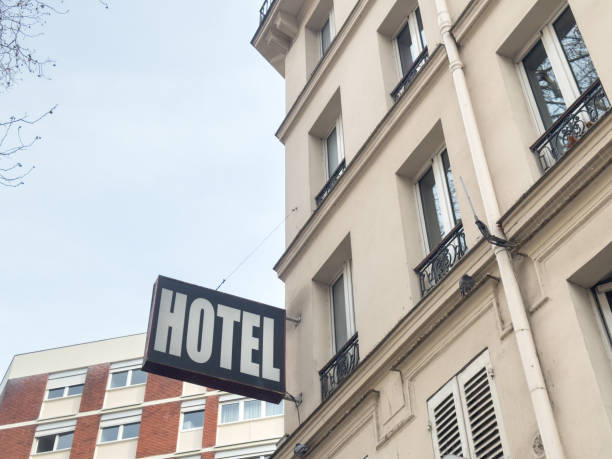 Close-up view of hotel sign on stone building facade with cast iron balconies. Santiago de Compostela, Galicia, Spain.