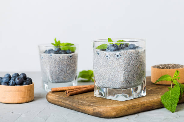 istock Healthy breakfast or morning with chia seeds vanilla pudding and blueberry berries on table background, vegetarian food, diet and health concept. Chia pudding with coconut milk and blueberry 2200323998