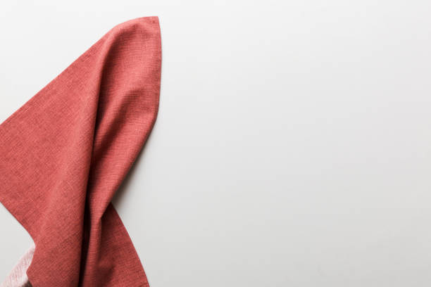 istock top view with red empty kitchen napkin isolated on table background. Folded cloth for mockup with copy space, Flat lay. Minimal style 2200324020