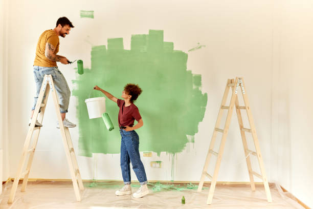 istock Happy couple talking while painting their new apartment. 2200324247