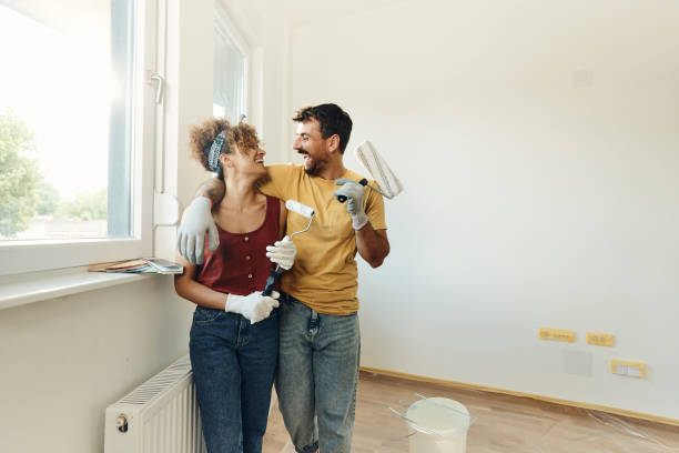 Cheerful couple talking during home renovation process.
