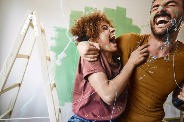 istock Cheerful couple having fun during home renovation process. 2200325001