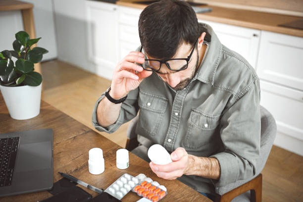istock man in interior of kitchen taking medication 2200326584