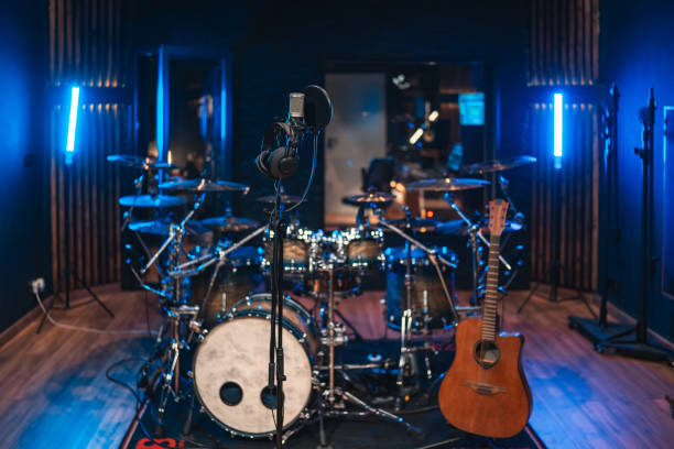 istock Recording studio ready for a music session with drum kit, guitar, and microphone 2200326882