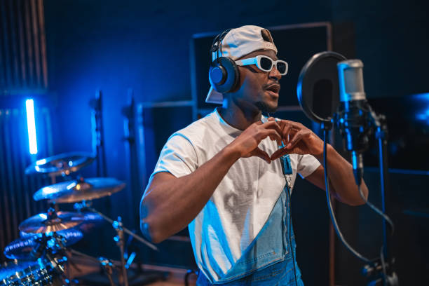 istock Young african american singer making heart shape with hands while recording song 2200326940