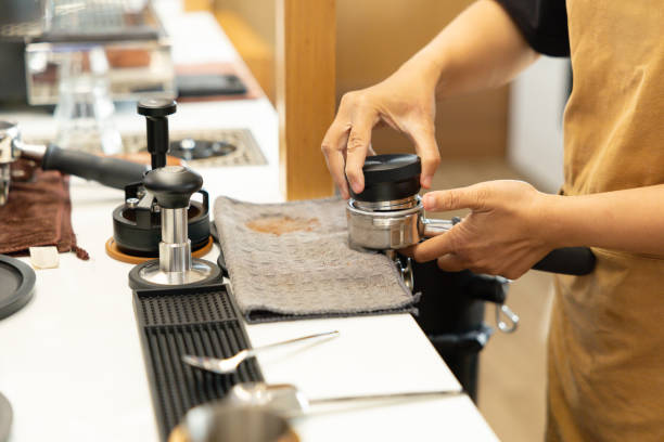 istock A barista is preparing a coffee drink with a coffee grinder 2200330154