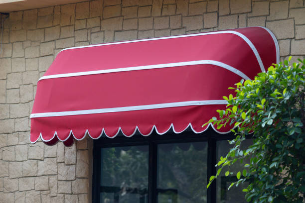istock A red awning with white trim is hanging over a window 2200330165