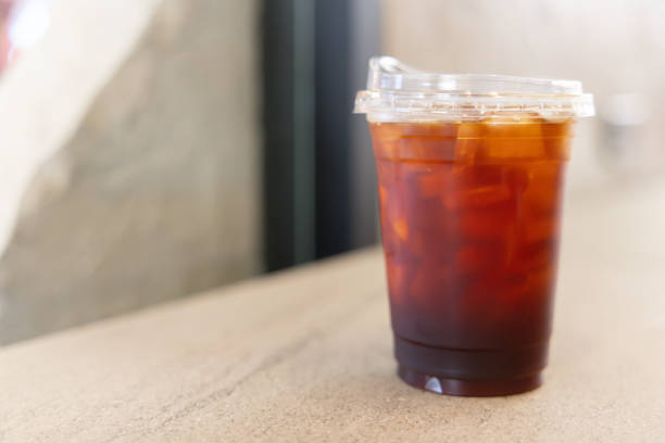 istock A cup of coffee with ice cubes in it sits on a table 2200330215