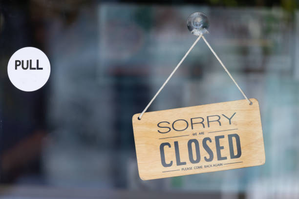 istock A sign hanging from a window that says Sorry I am closed 2200330232