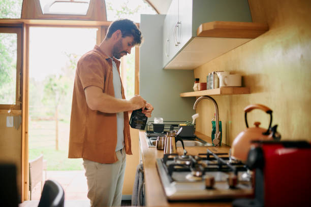 istock Moka pot, man and coffee beans preparation in kitchen for espresso brew, morning routine and caffeine break. Person, granules and stovetop appliance in home for start day, sweet drink and beverage 2200331943