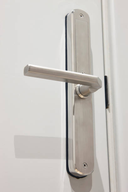 istock Metallic door handle on a white door. Hotel room interior 2200332632