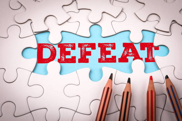 istock Defeat. White puzzle pieces and colored pencils 2200332892