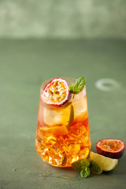 istock Fruit ice tea. Refreshing summer drink with syrup, passion fruit, lime, mint and ice. Glass with cold and healthy beverage 2200333518