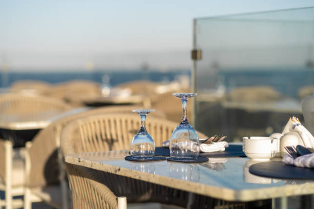 istock Romantic dining setting by the sea, featuring elegant tables, glassware 2200335477