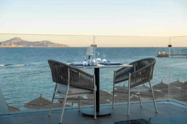 istock Luxury seaside dining at sunset, with beautifully arranged tables and shimmering 2200335606