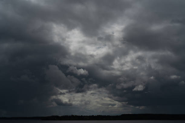 Gloomy gray rain clouds in the sky. Atmospheric natural background.
