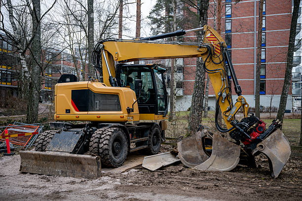 istock yellow wheeled excavator with a hydraulic grapple attachment at an urban construction site 2200341502