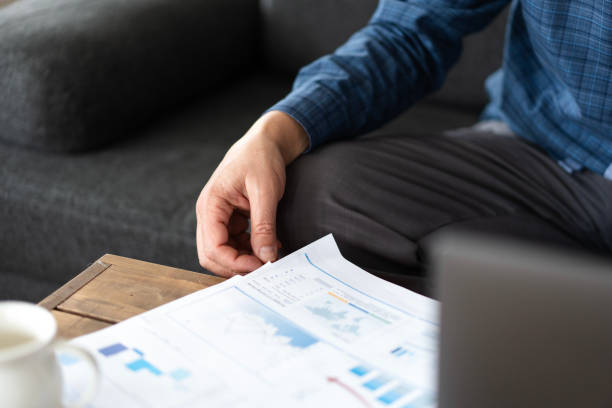 istock Businessman analyzing financial reports and charts at home office 2200341832