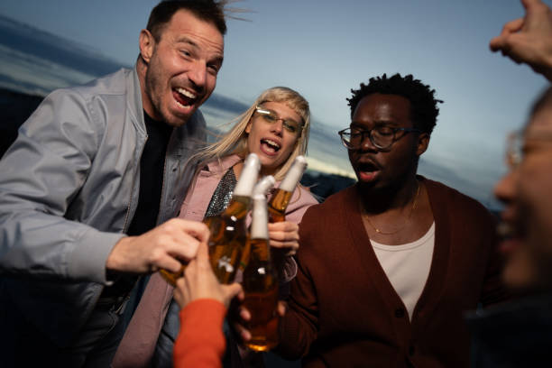 Multi ethnic young adults enjoying on a party outdoor.