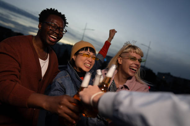 Multi ethnic young adults enjoying on a party outdoor.