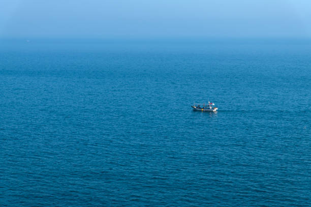 istock fishing boat sailing on the sea 2200346714