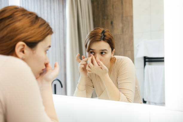 istock Woman Putting on Contact Lenses in Bathroom During Morning Routine 2200346747