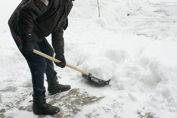 istock Shoveling Thick Snow from Sidewalk During Winter Storm 2200346847