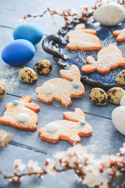 istock Homemade almond bunny cookies for Easter with Easter eggs in blue tone 2200348226