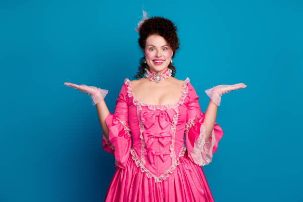 istock Photo of gorgeous pretty lady dressed pompous rococo costume comparing arms empty space isolated blue color background 2200349563