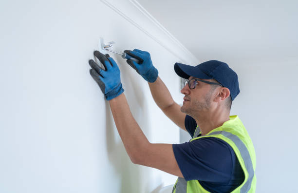 istock Worker Installing Sidewall Fire Sprinkler At Hotel Room Wall 2200350626
