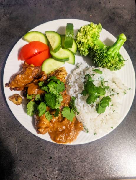 istock Satay chicken homemade dinner with vegetables and rice 2200350975