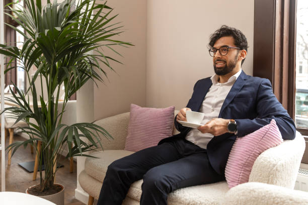 istock Pakistani businessman having coffee at a local cafe 2200356195