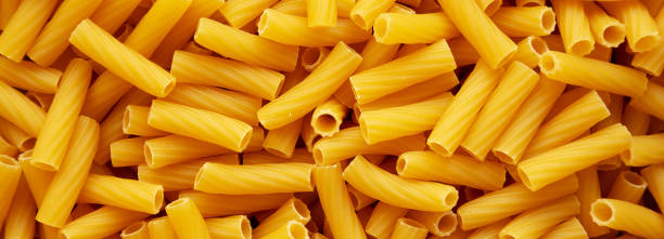 istock Dry Rigatoni Pasta background, top view. 2200356698