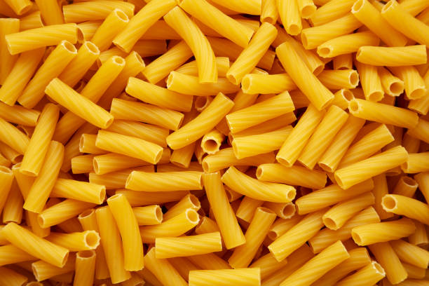 istock Dry Rigatoni Pasta background, top view. 2200356715