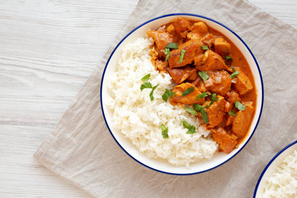 Homemade Easy Indian Butter Chicken with Rice on a Plate, top view. Flat lay, overhead, from above. Copy space. Homemade Easy Indian Butter Chicken with Rice on a Plate, top view. Flat lay, overhead, from above. Copy space. Butter Chicken stock pictures, royalty-free photos & images
