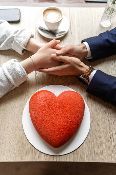 Focus on a mixed race couple having a date at a local cafe on Valentine's Day