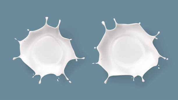 istock Splashed milk isolated. Natural dairy products, yogurt or cream in crown splashes with flying drops. 2200359408