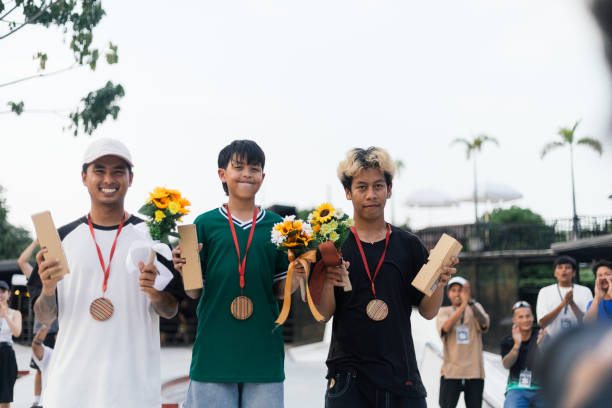 Outdoor sports event winners posing with medals and flowers