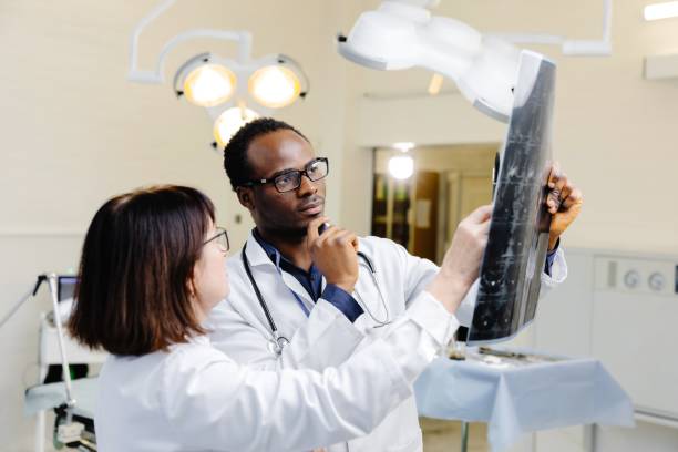 istock Man and woman in white lab coats conducting experiment 2200360330