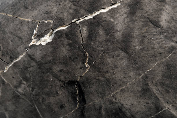 istock plaster background in gray-black color with cracks 2200365080